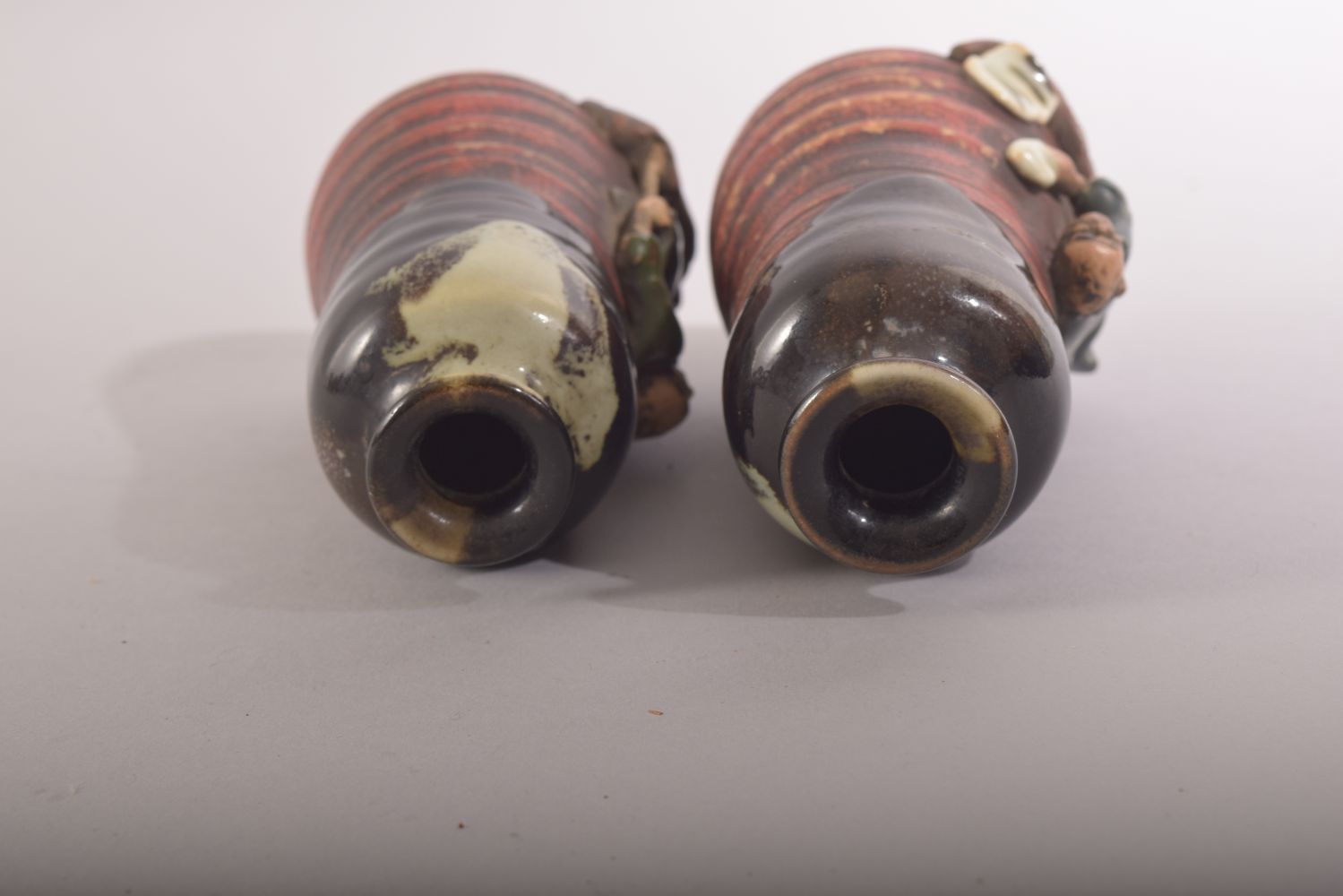 AN UNUSUAL PAIR OF SMALL JAPANESE FIGURAL POTTERY VASES, the rim and neck glazed, with two moulded - Image 5 of 6