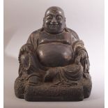 A CHINESE BRONZE SEATED BUDDHA, with faint traces of red and gilt, 26.5cm high.