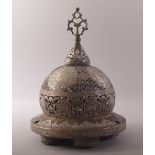 A SUPERB ISLAMIC SILVER AND COPPER OVERLAID OPENWORK BRONZE MOSQUE LAMP, the cover opening to reveal