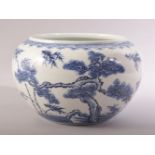 A CHINESE BLUE AND WHITE PORCELAIN BOWL / VASE, decorated with native flora, 24cm diameter.