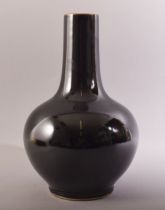 A CHINESE FAMILLE NOIR BULBOUS PORCELAIN VASE, with six character mark to base, 33cm high.