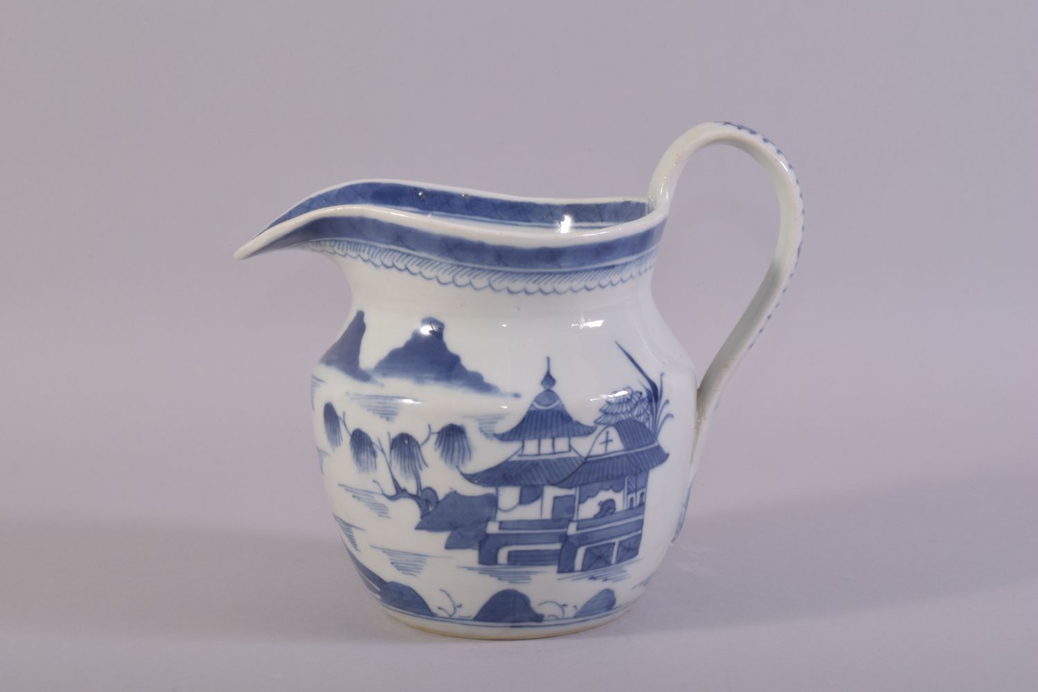 A CHINESE BLUE AND WHITE PORCELAIN JUG, decorated with a landscape scene depicting buildings, - Image 3 of 6