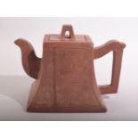 A CHINESE YIXING TEAPOT, with script to one side and mark to inner lid and base, 12.5cm high.