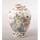 A SMALL CHINESE FAMILLE ROSE CADDY / VASE, painted with flowers with pierced vine base, 9.5cm high.