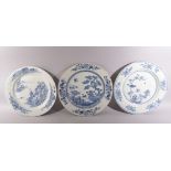 THREE LARGE CHINESE BLUE AND WHITE PORCELAIN DISHES, one painted with a landscape and buildings, one