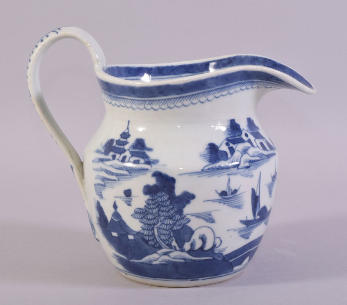 A CHINESE BLUE AND WHITE PORCELAIN JUG, decorated with a landscape scene depicting buildings,