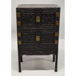 A GOOD CHINESE HARDWOOD / HONGMU FOUR DOOR CABINET on stand, the front profusely carved with a
