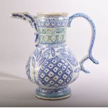 A TURKISH KUTAHYA GLAZED POTTERY WATER JUG, painted with blue decorative motifs, 24.5cm high.