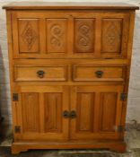 Mid to late 20th century drinks cabinet in oak with carved panels Ht118cm W91cm D38cm