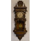 Vienna regulator wall clock in an ornate walnut case with brass embellishments & a 2 train spring