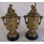 Pair of classical style gilt metal lidded urns decorated with cherubs and vines H 40 cm