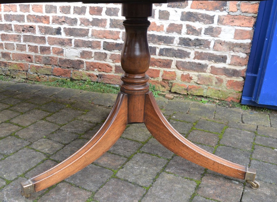 Regency style mahogany twin pedestal dining table on sabre legs with removable leaf extending to 2. - Image 3 of 3