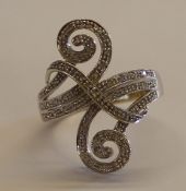 Tested as 14ct white gold (marked 14K) fancy scroll ring set with 68 brilliant cut diamonds, each