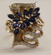 Tested as 14ct gold (marked 14k) sapphire and diamond ring, with 13 marquise cut sapphires 4 x 2.