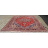 Large red ground Persian Tabriz carpet, multi coloured floral pattern, 390cm x 296cm