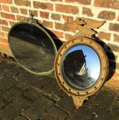 Regency style gilt framed convex mirror with eagle mount H 71 cm and a bevel edge oval mirror L 77.5