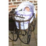 Dolls pram with an Ashton Drake doll