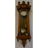 Vienna regulator wall clock in a walnut case with a single train weight driven mechanism with turned