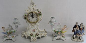 Sitzendorf floral encrusted clock, pair of cherub candelabra and Unter Weiss Bach figural group