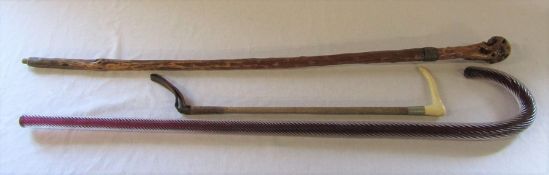 Glass candy cane walking stick, wooden walking stick and a riding crop