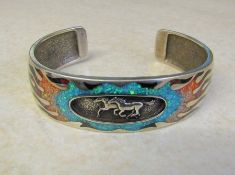 Solid silver cuff bracelet depicting galloping horses inlaid with gemstone flame design D 7 cm