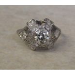 Tested as platinum vintage style diamond cluster ring set with central brilliant cut diamond