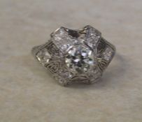 Tested as platinum vintage style diamond cluster ring set with central brilliant cut diamond