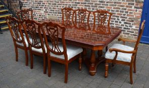 Mixed wood veneer twin pedestal dining table with single removable leaf and 8 chairs extending to