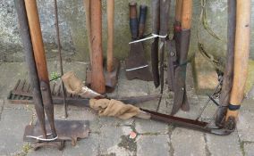 Vintage tools including scythes, billhooks, pick axe, 2 sledge hammers, hedge cutters, hoes & rakes