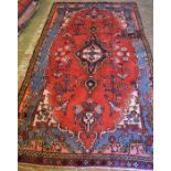 Blue & red ground Persian sarouk carpet with floral medallion (some repairs)  268cm by 145cm