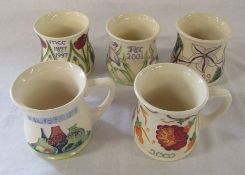 5 Moorcroft mugs - 4 collectors mug 1999, 2001, 2002 and 1897-1997 and a 1989 Museum mug H 9 cm