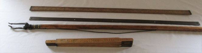 Measuring sticks / rulers and a vintage wooden grabber / picking stick