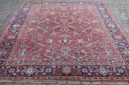 Red ground carpet with geometric design (some damage) 222cm x 305cm