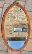 Edwardian oval wall mirror with carved top 73cm by 39cm