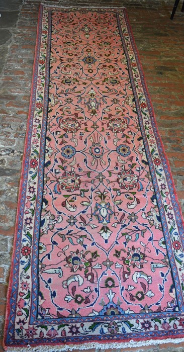 Pink ground Iranian hand woven runner with all over floral pattern 307cm by 81cm