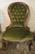 Victorian button back nursing chair in green velvet on scroll legs