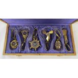 Boxed collection of brass nautical keyrings / compasses