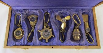 Boxed collection of brass nautical keyrings / compasses