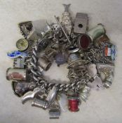 Silver charm bracelet with large quantity of silver and white metal charms total weight 5.63 ozt /