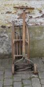 Vintage hand push lawnmower and a wooden sledge