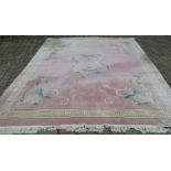 Large pink ground Chinese carpet with dragon motifs 370cm by 280cm