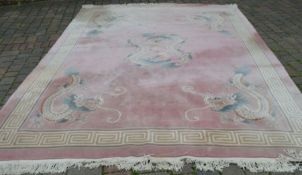 Large pink ground Chinese carpet with dragon motifs 370cm by 280cm