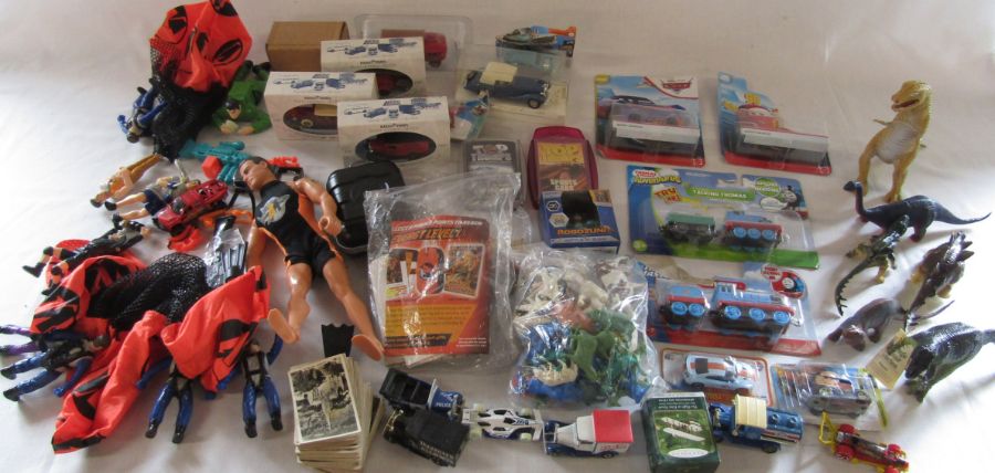 Box of assorted toys inc Action Man, Top Trumps, dinosaurs, die cast cars etc