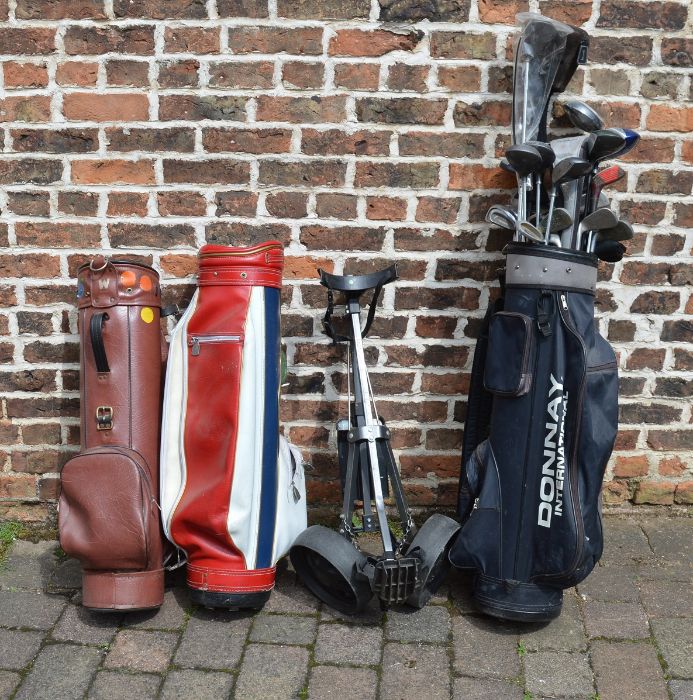 Various golf club, bags and a trolley