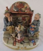 Large Capodimonte figural group consisting of grandparents sitting beside a fireplace with a young