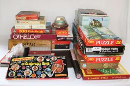 Selection of board games including Monopoly, rubik's cubes, jigsaw puzzles, Camberwick Green