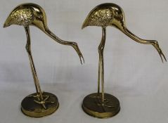 Pair of decorative brass storks holding fish, 45cm high