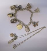 Silver charm bracelet and silver necklace with miniature silver ingot, drama pendant and St