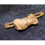 Piece of gold ore set in 18ct gold claw mount, on 9ct gold bar brooch