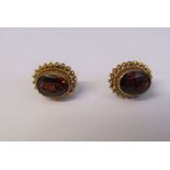 Boxed pair of 9ct gold garnet solitaire earrings, total weight 1.9 g